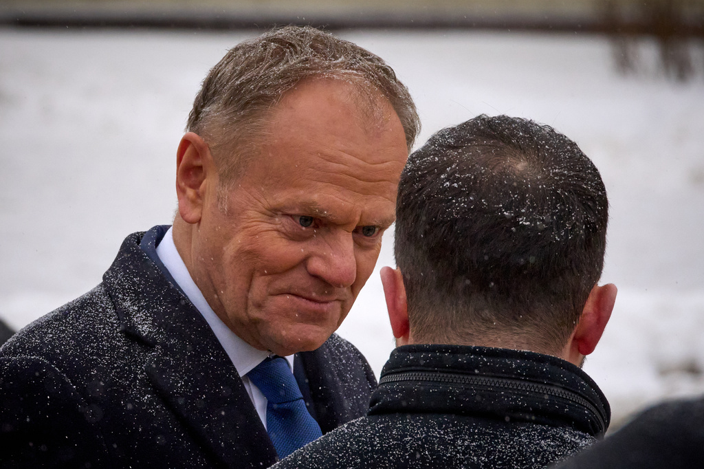 Poland's Prime Minister Donald Tusk, left, talks with Ukrainian President Volodymyr Zelenskyy after a commemorative ceremony at the Memorial Wall of Fallen Defenders of Ukraine in Kyiv, Ukraine, Thursday, Feb. 5, 2026. (AP Photo/Efrem Lukatsky)