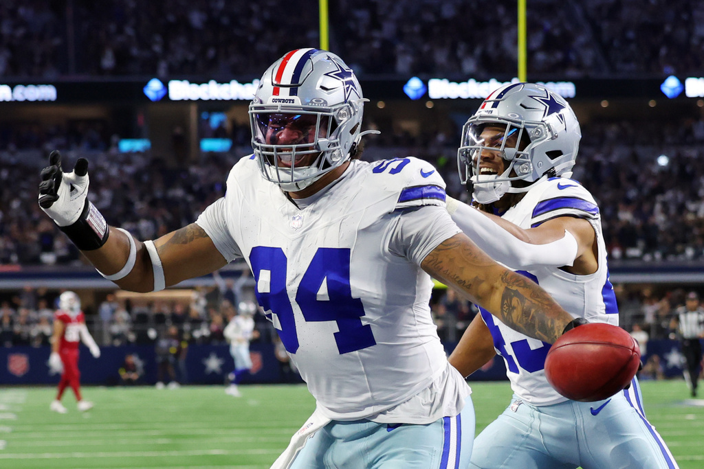 Dallas Cowboys defensive end Marshawn Kneeland (94) celebrates with Malik Davis (43) after he recovered a blocked punt for a touchdown in the first half of an NFL football game against the Arizona Cardinals first half of an NFL football game Monday, Nov. 3, 2025, in Arlington, Texas. (AP Photo/Richard Rodriguez)