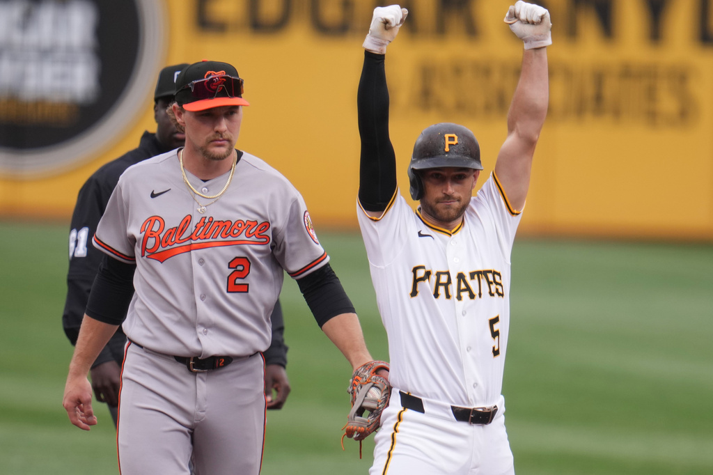 Pittsburgh Pirates' Brandon Lowe (5) celebrates as Baltimore Orioles shortstop Gunnar Henderson (2) holds the tag after hitting a double during the first inning of a baseball game in Pittsburgh, Friday, April 3, 2026. (AP Photo/Gene J. Puskar)