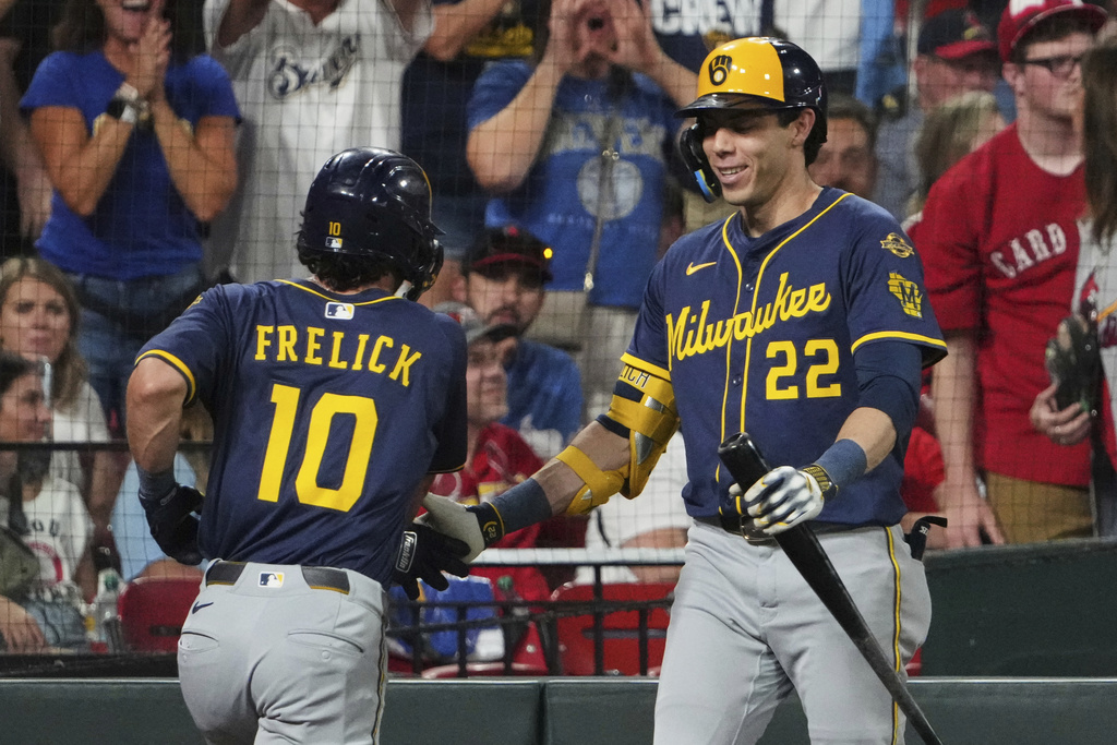 Milwaukee Brewers' Sal Frelick (10) is congratulated by teammate Christian Yelich (22) after hitting a solo home run during the third inning of a baseball game against the St. Louis Cardinals Friday, Sept. 19, 2025, in St. Louis. (AP Photo/Jeff Roberson)