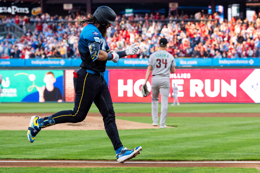 Philadelphia Phillies' Brandon Marsh, left, runs the bases after hitting a three-run home run off Arizona Diamondbacks starting pitcher Mike Soroka (34) during the first inning of a baseball game, Friday, April 10, 2026, in Philadelphia. (AP Photo/Chris Szagola)