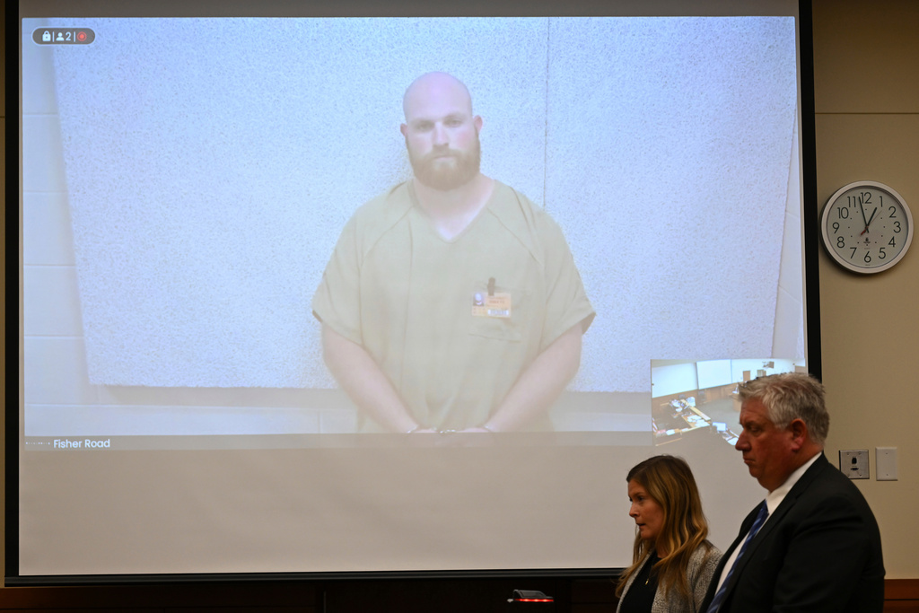 FILE - Blendon Township police officer Connor Grubb listens while appearing via video from jail for his arraignment hearing, Aug. 14, 2024, at the Franklin County Court of Common Pleas in Columbus. (AP Photo/David Dermer, File)
