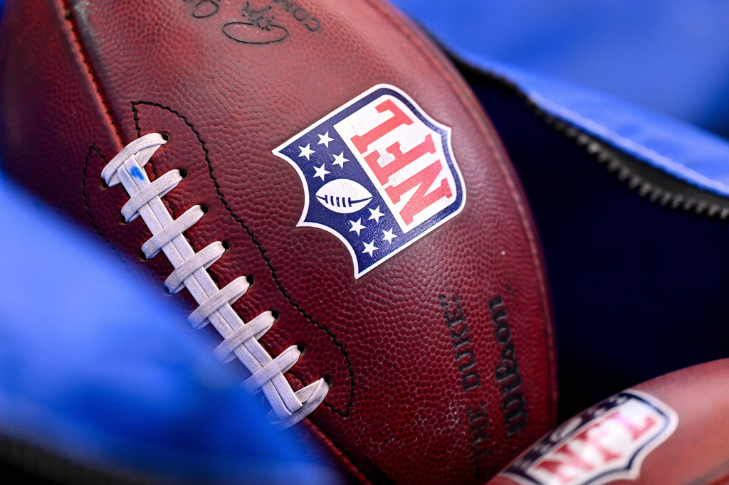 FILE - A detail view of the NFL shield on a football prior to an NFL football game between the Houston Texans and the Indianapolis Colts on Jan. 4, 2026, in Houston. (AP Photo/Maria Lysaker, File)