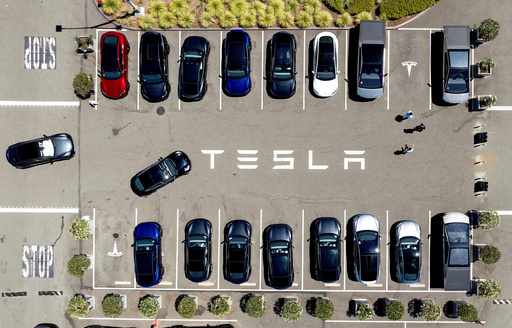 FILE - Tesla vehicles line a parking area at the company's Fremont, Calif., factory, Aug. 5, 2025. (AP Photo/Noah Berger) FILE - Tesla vehicles line a parking area at the company's Fremont, Calif., factory, Aug. 5, 2025. (AP Photo/Noah Berger)