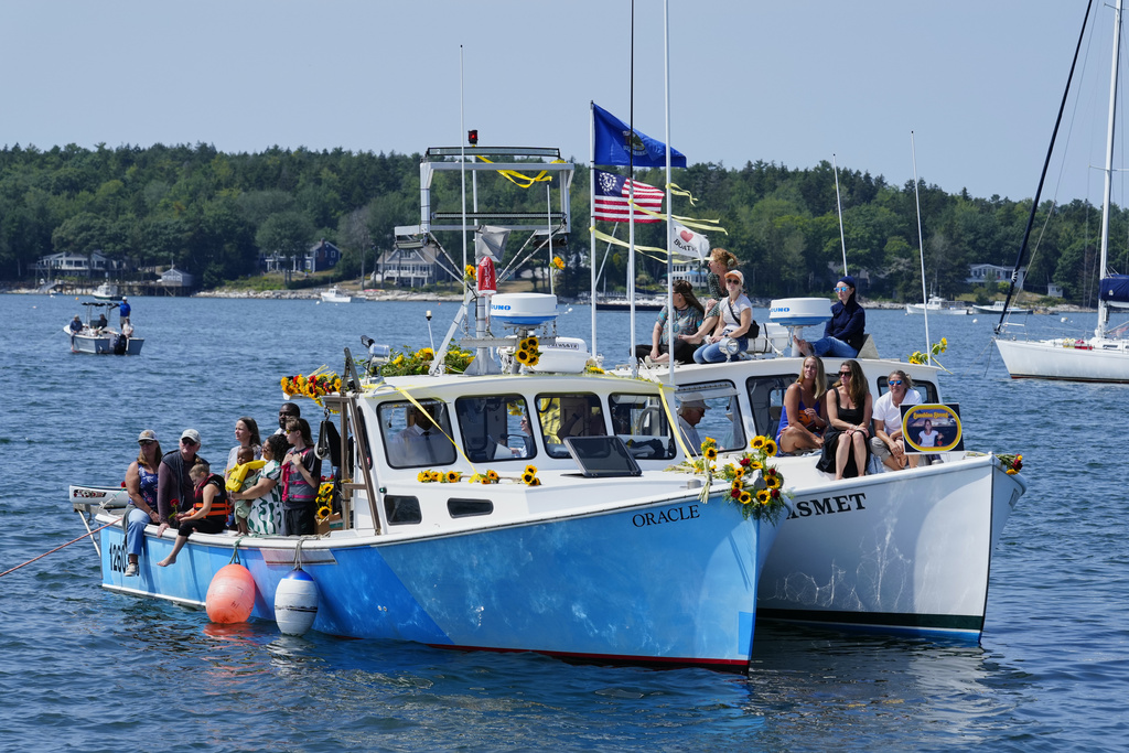 Friends and family attend a memorial service for Sunshine Stewart, Sunday, Aug. 10, 2025, off the coast of St. George, Maine. (AP Photo/Robert F. Bukaty)