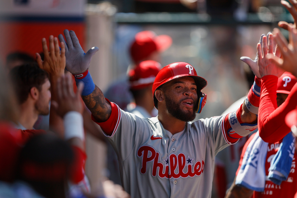 Philadelphia Phillies' Edmundo Sosa (33) is greeted by teammates after hitting a solo home run during the seventh inning of a baseball game against the Los Angeles Angels, Sunday, Aug. 30, 2026, in Anaheim, Calif. (AP Photo/Caroline Brehman)