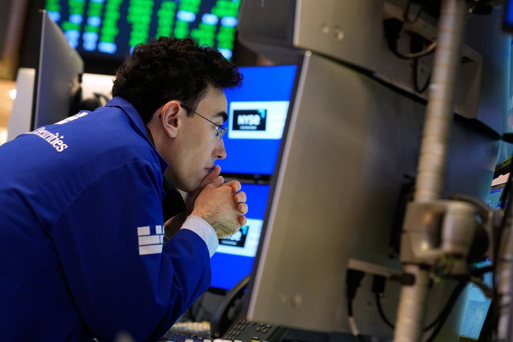 Alexander Weitzman works on the floor at the New York Stock Exchange in New York, Tuesday, Jan. 6, 2026. (AP Photo/Seth Wenig)