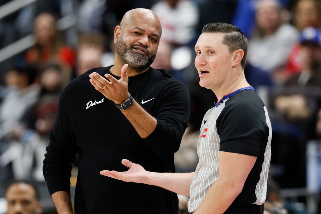 Detroit Pistons head coach J.B. Bickerstaff, left, talks with referee Ed Malloy during the first half of an NBA basketball game against the Phoenix Suns Thursday, Jan. 15, 2026, in Detroit. (AP Photo/Duane Burleson)