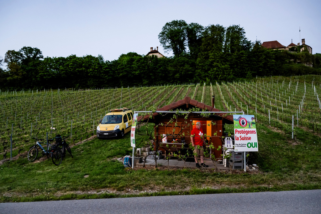 An electoral poster for the right-wing Swiss People's Party (SVP) popular initiative "No 10-million-Switzerland" is pictured in a vineyard owned by Olivier Agassis, a winemaker and member of the Vaud cantonal parliament, in Bavois, Switzerland, May 1, 2026. (Jean-Christophe Bott/Keystone via AP)