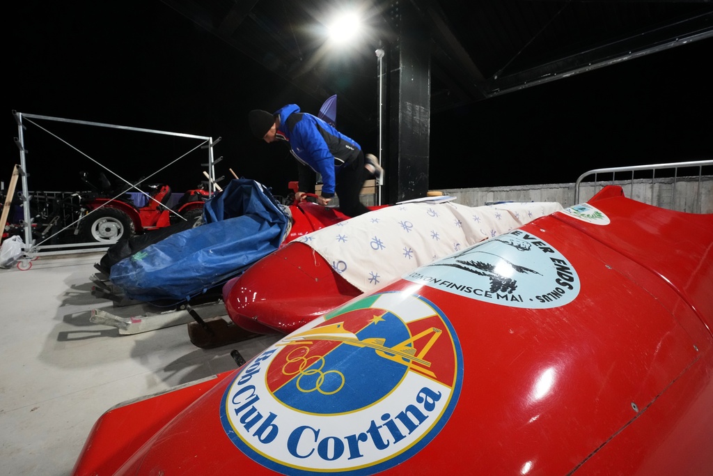 A forerunner practices on his bobsled during a training session ahead of a three-day skeleton and bobsled World Cup stage and Olympic test event in Cortina D'Ampezzo, Italy, Wednesday, Nov. 19, 2025. (AP Photo/Andrew Medichini)