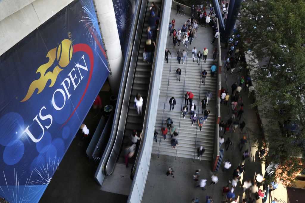 FILE - Tennis fans move in and out of Arthur Ashe Stadium during the fourth round of the U.S. Open tennis tournament in New York, Sept. 3, 2017. The U.S. Open, the year's last Grand Slam tennis tournament, starts Monday.(AP Photo/Frank Franklin II, File)