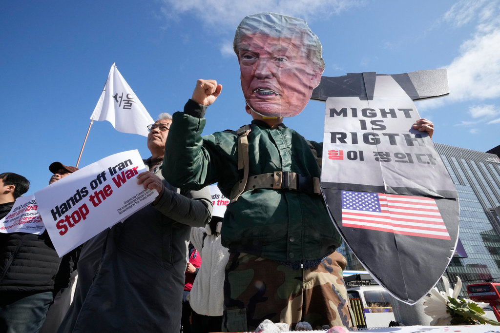 A South Korean protester wearing a mask of U.S. President Donald Trump attends a press conference denouncing the U.S. and Israel's attack on Iran, near the U.S. Embassy in Seoul, South Korea, Tuesday, March 3, 2026. (AP Photo/Ahn Young-joon)