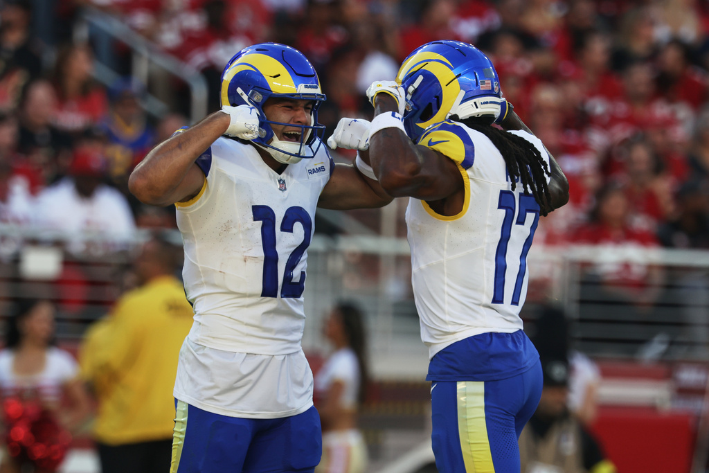 Los Angeles Rams wide receiver Puka Nacua (12) is congratulated by wide receiver Davante Adams after scoring against the San Francisco 49ers during the first half of an NFL football game in Santa Clara, Calif., Sunday, Nov. 9, 2025. (AP Photo/Jed Jacobsohn)