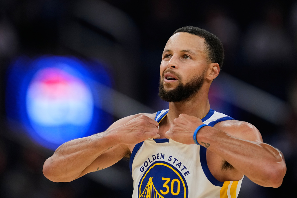 Golden State Warriors guard Stephen Curry reacts during the first half of an NBA basketball preseason game against the Portland Trail Blazers, Wednesday, Oct. 8, 2025, in San Francisco. (AP Photo/Godofredo A. V&aacute;squez)