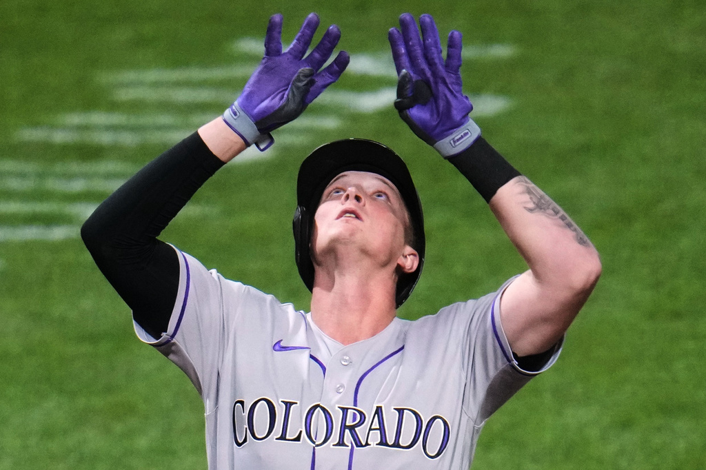 Colorado Rockies' TJ Rumfield celebrates as he crosses home plate after hitting a solo home run off Pittsburgh Pirates pitcher Brandon Bidois during the eighth inning of a baseball game in Pittsburgh, Wednesday, May 13, 2026. (AP Photo/Gene J. Puskar)