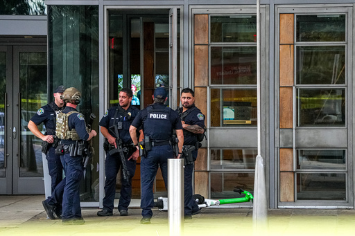 Austin Police Department officers wait outside after responding to a call for a shooting the Austin Public Library on César Chávez Street in downtown Austin, Texas on Saturday, Oct. 25, 2025. (Aaron E. Martinez/Austin American-Statesman via AP) Austin Police Department officers wait outside after responding to a call for a shooting the Austin Public Library on César Chávez Street in downtown Austin, Texas on Saturday, Oct. 25, 2025. (Aaron E. Martinez/Austin American-Statesman via AP)