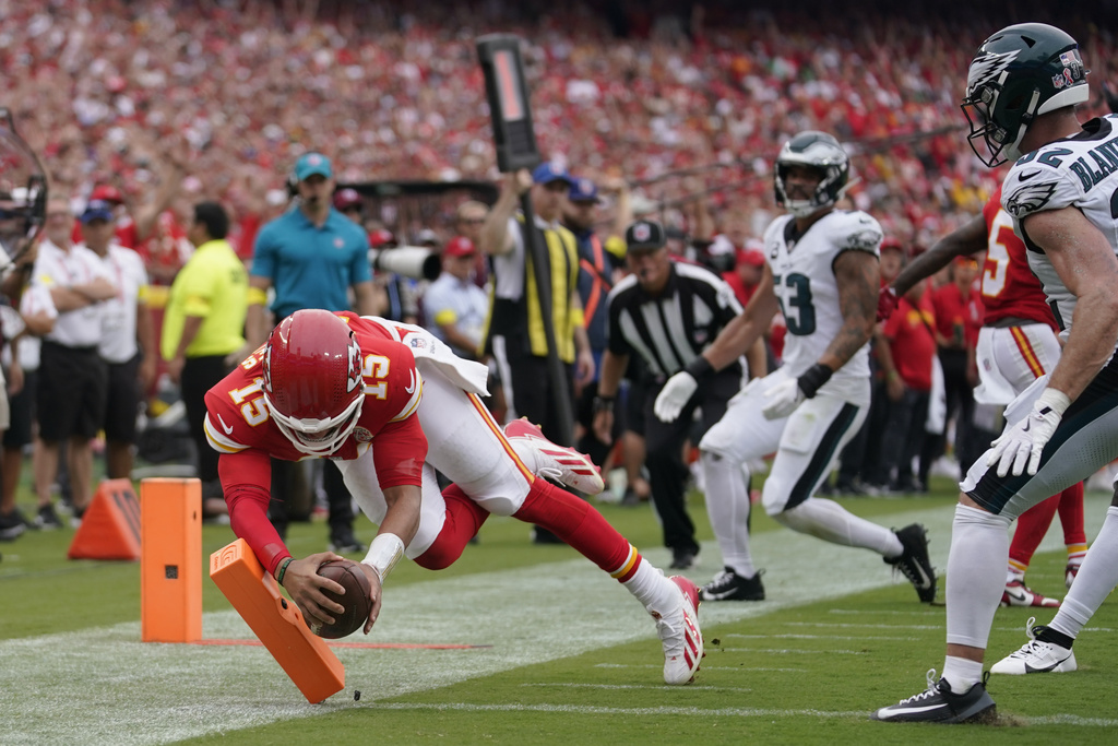Kansas City Chiefs quarterback Patrick Mahomes (15) scores during the first half of an NFL football game against the Philadelphia Eagles Sunday, Sept. 14, 2025, in Kansas City, Mo. (AP Photo/Ed Zurga)