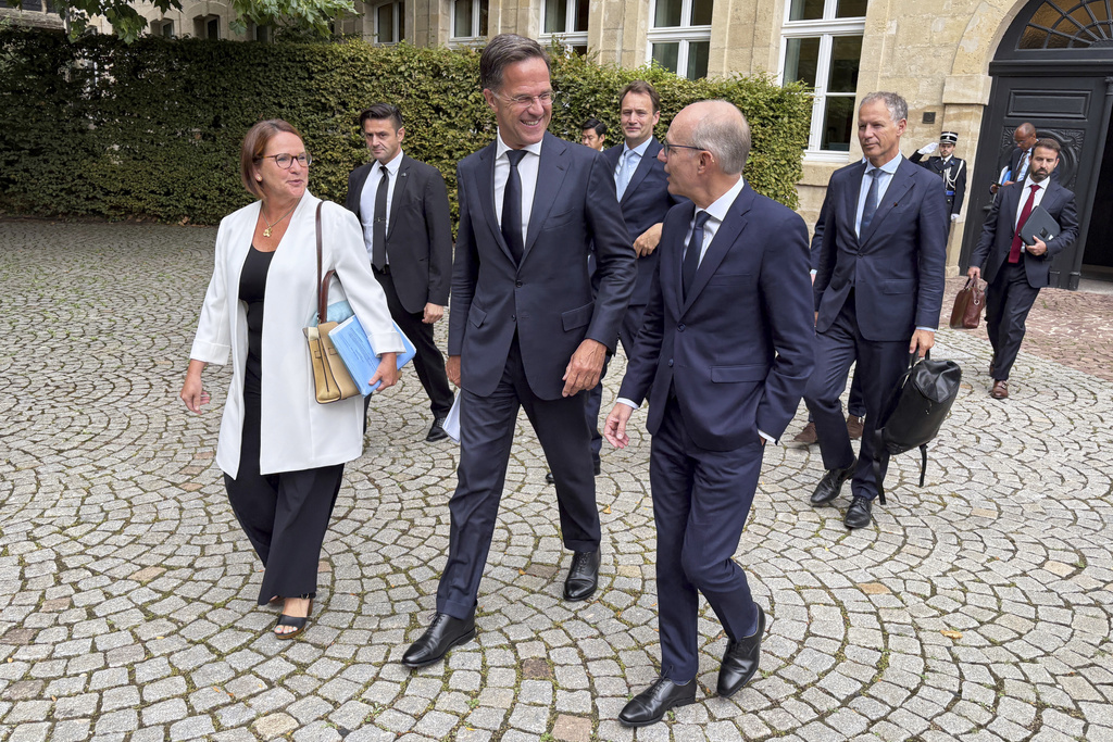 NATO Secretary General Mark Rutte, center, walks with Luxembourg's Prime Minister Luc Frieden, center right, and Luxembourg's Defense Minister Yuriko Backes, center left, prior to a meeting in Luxembourg, Tuesday, Sept. 2, 2025. (AP Photo/Sam McNeil)