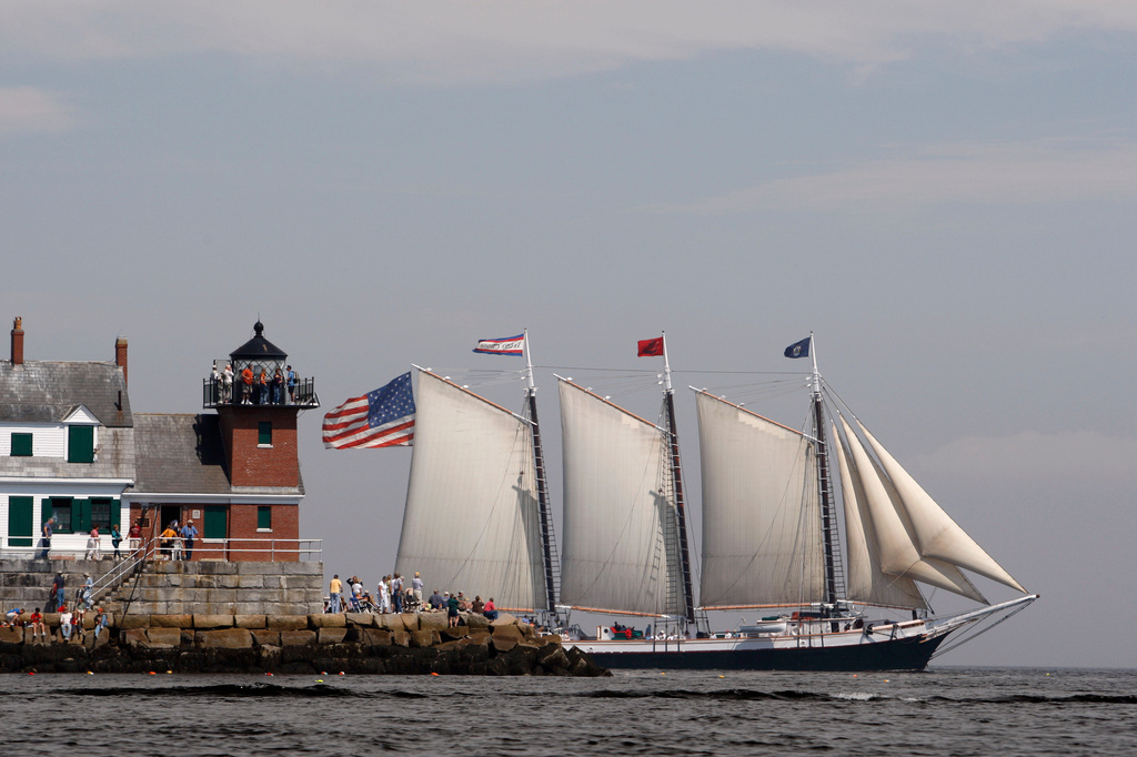 FILE - The Victory Chimes passes the Rockland Breakwater Lighthouse during the Maine Windjammer Parade, July 17, 2009, in Rockland, Maine. (AP Photo/Robert F. Bukaty, File)
