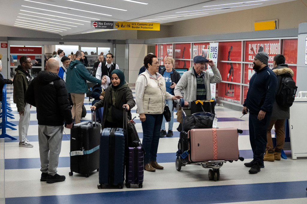 People walk out of the terminal upon their arrival from Amman, Jordan at John F. Kennedy International Airport in New York, Thursday, March 5, 2026. (AP Photo/Yuki Iwamura)