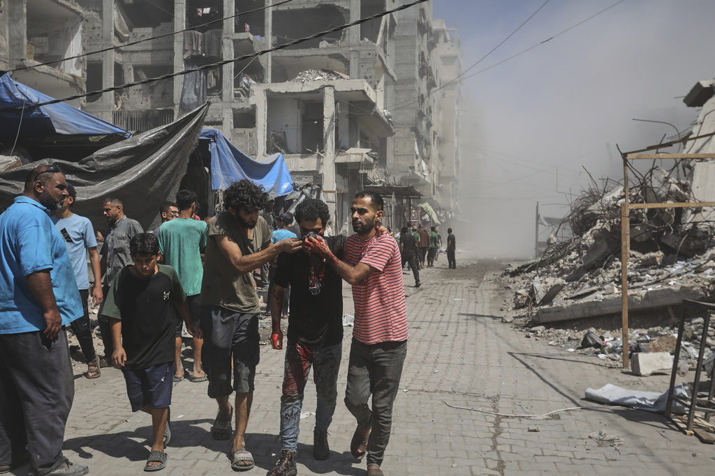 Palestinians evacuate a man who was injured in an Israeli military strike on a building in Gaza City, Saturday, Sept. 13, 2025. (AP Photo/Yousef Al Zanoun)