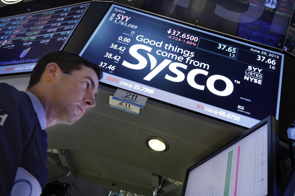 FILE - Specialist John McNierney works at the post that handles Sysco, on the floor of the New York Stock Exchange, Monday, June 29, 2015. (AP Photo/Richard Drew, file)