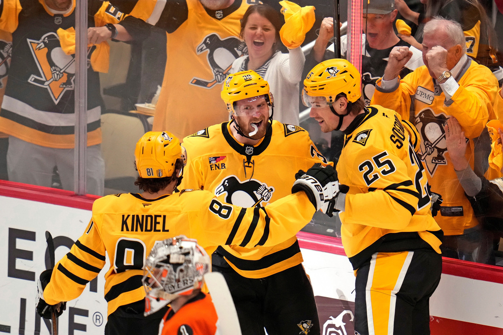 Pittsburgh Penguins' Elmer Soderblom (25) celebrates with Ben Kindel (81) and Anthony Mantha (39) after scoring against the Philadelphia Flyers during the first period of Game 5 in the first round of an NHL hockey Stanley Cup playoff series in Pittsburgh, Monday, April 27, 2026. (AP Photo/Gene J. Puskar)