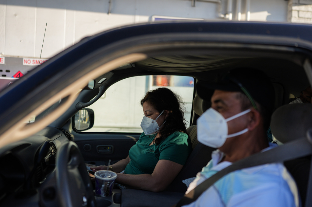 Two evacuees sit in their pickup truck at a gas station within the evacuation zone in Stanton, Calif., Monday, May 25, 2026. (AP Photo/Jae C. Hong)
