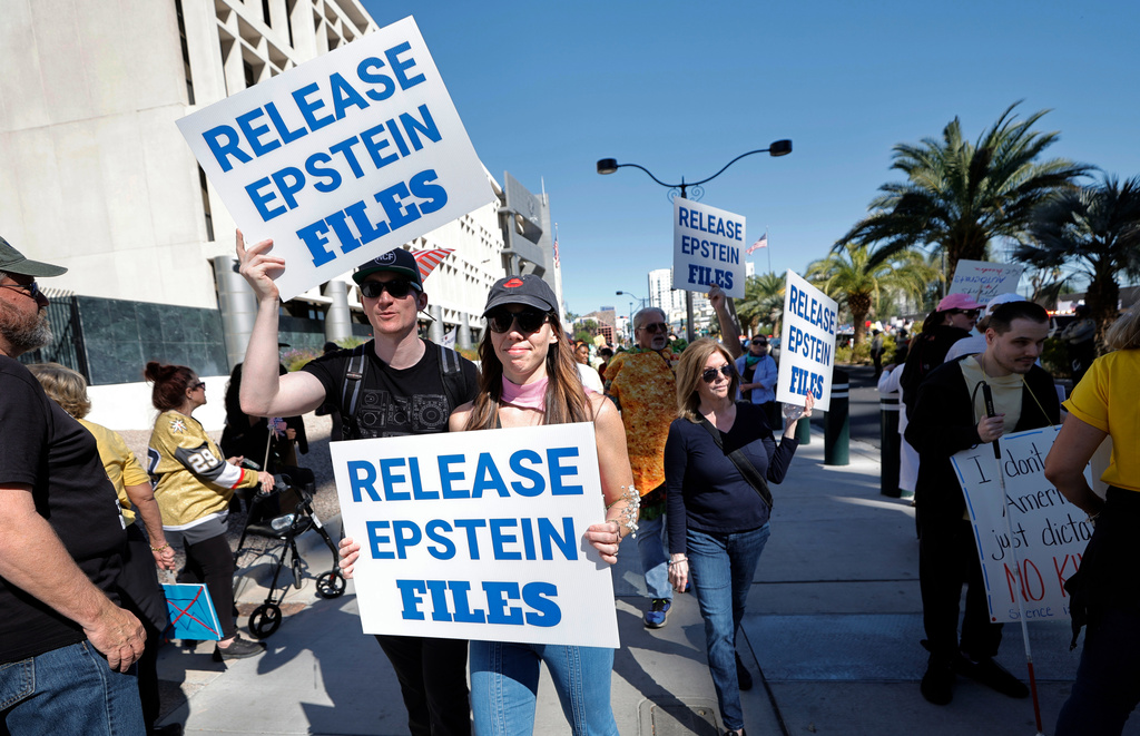 Demonstrators hold signs asking for the release of the Epstein files during a "No Kings" protest in downtown Las Vegas Saturday, Oct. 18, 2025. (Steve Marcus /Las Vegas Sun via AP)
