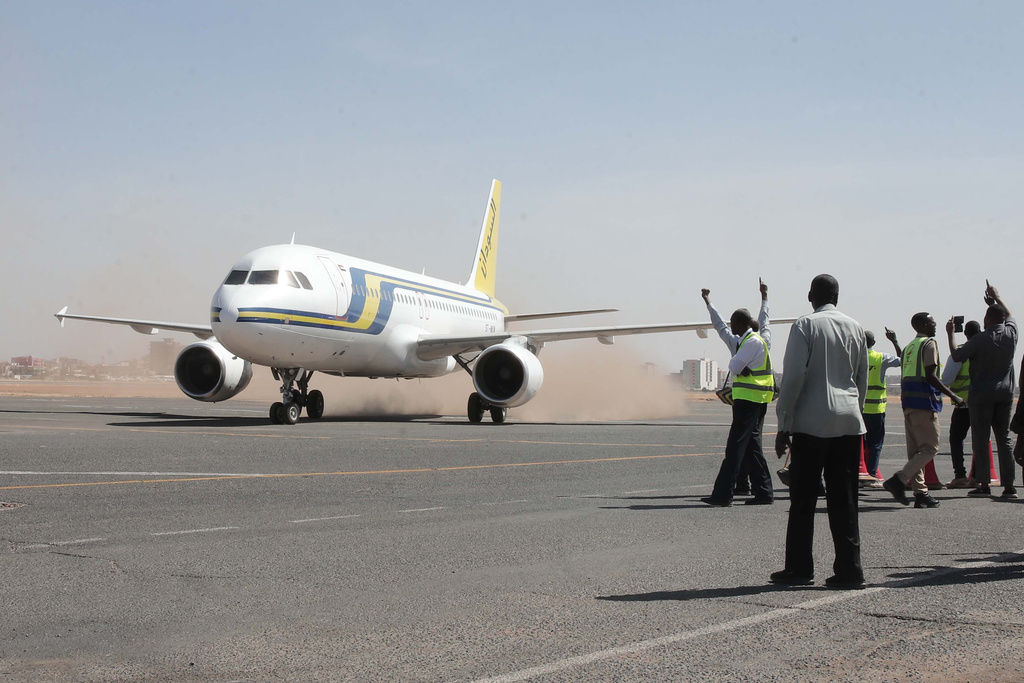 Khartoum International Airport ground workers greet the first domestic Sudan Airways flight landing from Port Sudan, following the war between Sudan's army and the paramilitary Rapid Support Forces, in Khartoum, Sudan, Sunday, Feb. 1, 2026. (AP Photo/Marwan Ali)