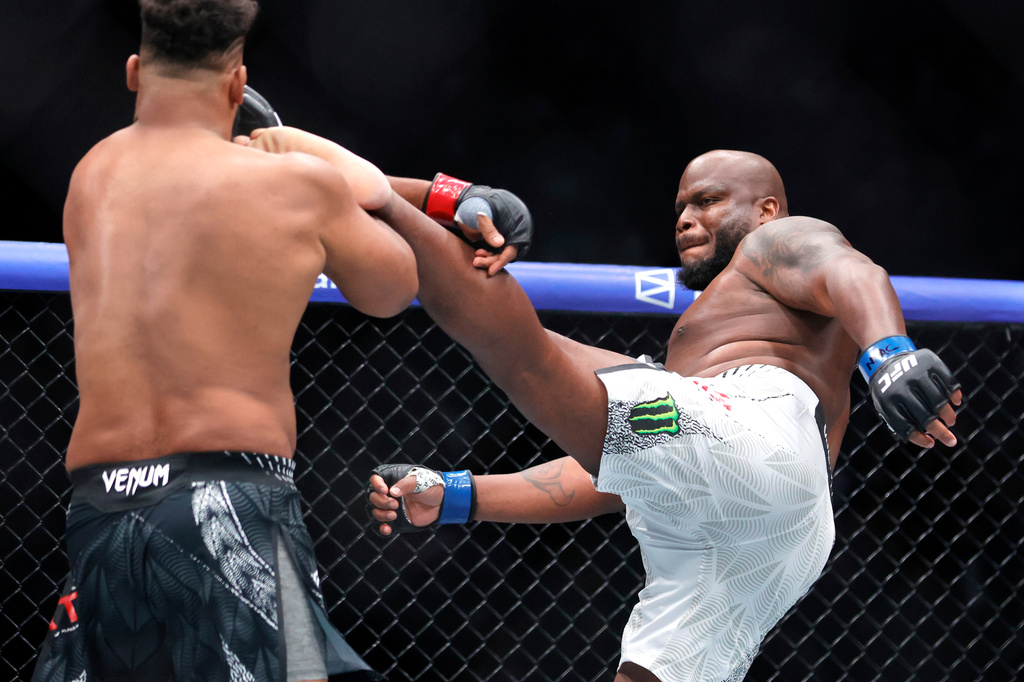 FILE - Derrick Lewis, right, kicks Waldo Cortes Acosta in a heavyweight bout during the UFC 324 mixed martial arts event, Jan. 24, 2026, in Las Vegas. (AP Photo/Steve Marcus, File)