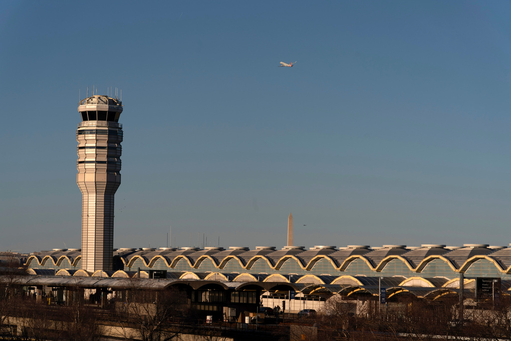 FILE - The air traffic control tower at Ronald Reagan Washington National Airport is seen, Feb. 1, 2025, in Arlington, Va., near the wreckage of a mid-air collision between a Black Hawk helicopter and an American Airlines jet in the Potomac River. (AP Photo/Jose Luis Magana, File)