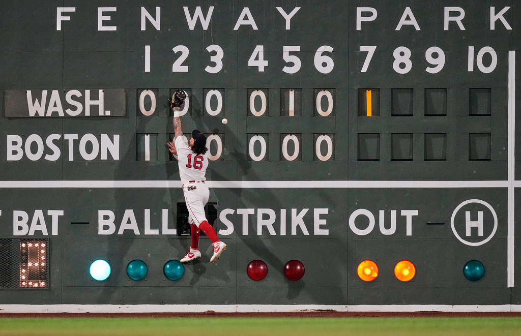 Boston Red Sox's Jarren Duran leaps but can't make the play on a two-run double by Washington Nationals' Luis García Jr. during the seventh inning of a baseball game, Tuesday, June 30, 2026, in Boston. (AP Photo/Charles Krupa)