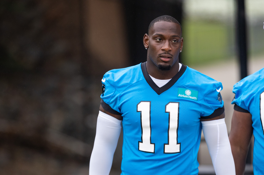 Carolina Panthers linebacker Nic Scourton (11) walks to the NFL football team's training camp Thursday, July 23, 2026, in Charlotte, N.C. (AP Photo/Scott Kinser)