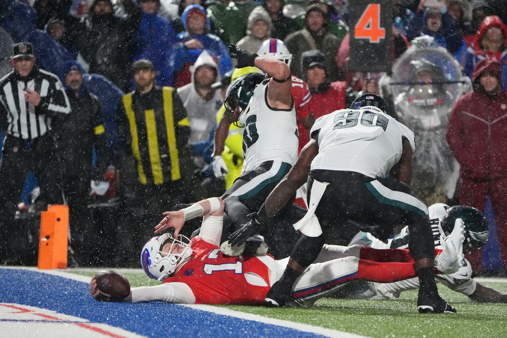 Buffalo Bills' Josh Allen (17) is tackled short of a touchdown by Philadelphia Eagles' Jaelan Phillips (50) and Jordan Davis (90) during the second half of an NFL football game, Sunday, Dec. 28, 2025, in Buffalo, N.Y. (AP Photo/Gene J. Puskar)