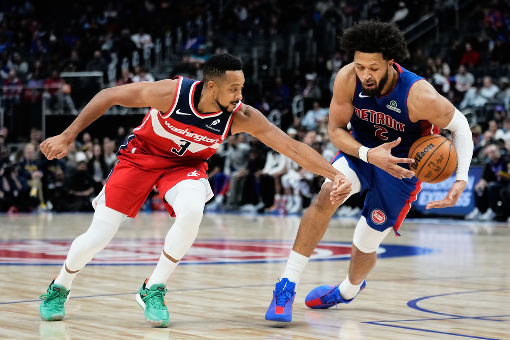 Detroit Pistons guard Cade Cunningham, right, steals the ball from Washington Wizards guard CJ McCollum during the first half of an NBA basketball game Monday, Nov. 10, 2025, in Detroit. (AP Photo/Ryan Sun)