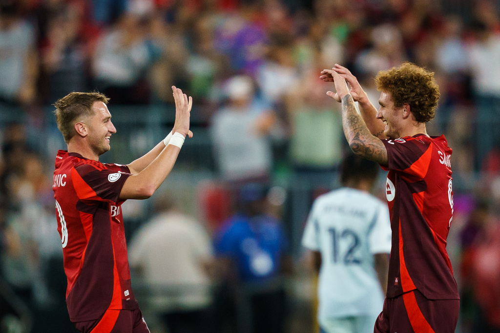 Toronto FC's Josh Sargent, left, celebrates his third goal against Chicago Fire FC with Djordje Mihailovic (10) during the second half of a soccer match in Toronto, Saturday, Sept. 5, 2026. (Keito Newman/The Canadian Press via AP)