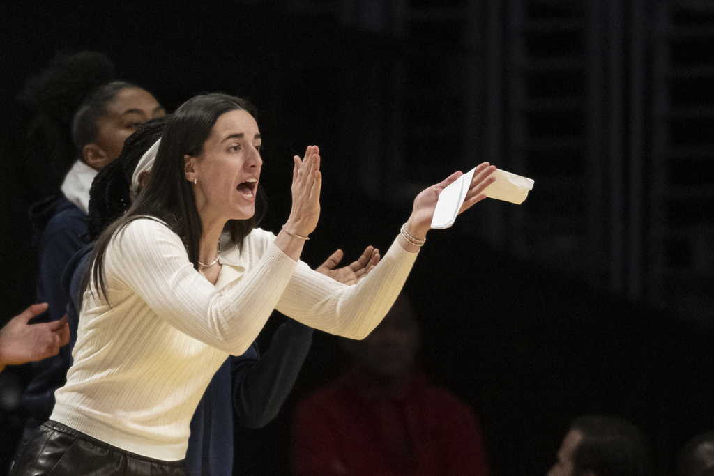 Indiana Fever guard Caitlin Clark cheers for teammates during the first half of a WNBA basketball game against the Los Angeles Sparks, Friday, Aug. 29, 2025, in Los Angeles. (AP Photo/Kyusung Gong)