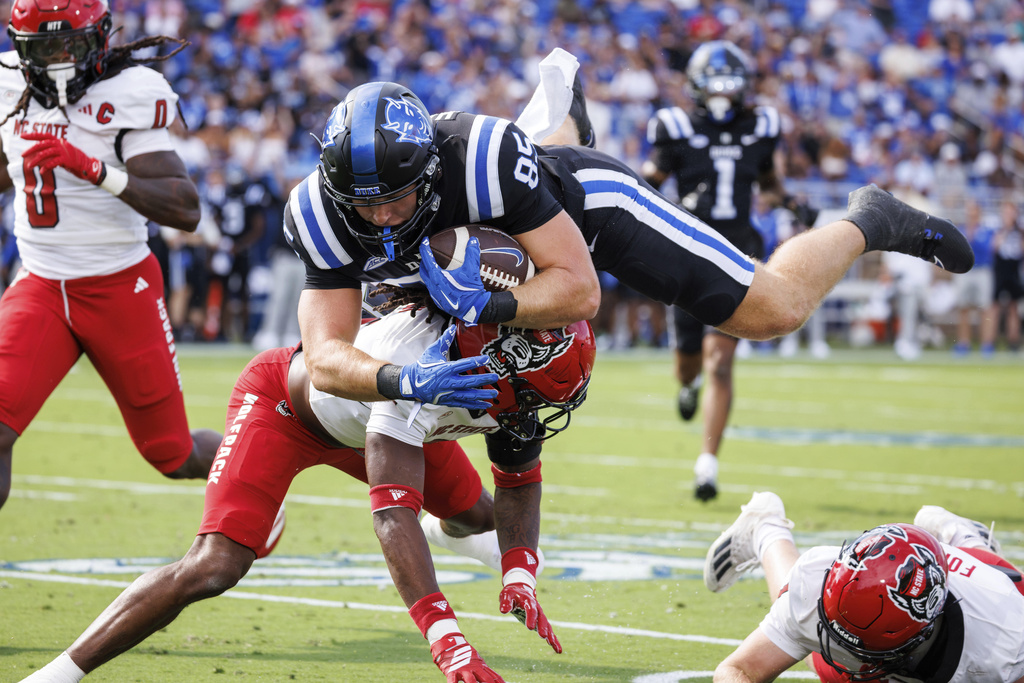 Duke's Jeremiah Hasley (85) is tackled by North Carolina State's Ronnie Royal III, left, during the first half of an NCAA college football game in Durham, N.C., Saturday, Sept. 20, 2025. (AP Photo/Ben McKeown)