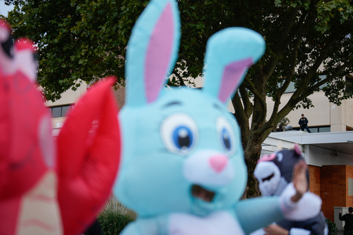 Law enforcement officers watch from a ledge on the a U.S. Immigration and Customs Enforcement facility, at right, as people in costumes protest on Saturday, Oct. 11, 2025, in Portland, Ore. (AP Photo/Jenny Kane) Law enforcement officers watch from a ledge on the a U.S. Immigration and Customs Enforcement facility, at right, as people in costumes protest on Saturday, Oct. 11, 2025, in Portland, Ore. (AP Photo/Jenny Kane)