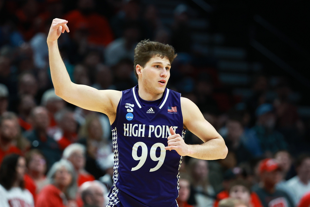 High Point guard Chase Johnston reacts after shooting a 3-pointer during the first half in the first round of the NCAA college basketball tournament against Wisconsin, Thursday, March 19, 2026, in Portland, Ore. (AP Photo/Craig Mitchelldyer)