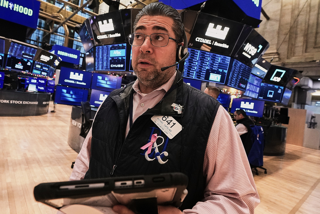 Trader Michael Capolino works on the floor of the New York Stock Exchange, Friday, Jan. 2, 2026. (AP Photo/Richard Drew)