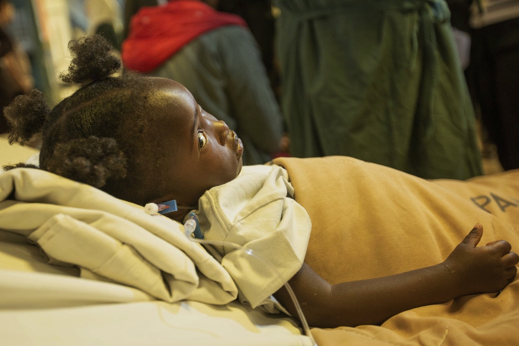 Kimberly Raisi lies on the bed as she recovers as she recovers from an open-heart surgery at Parirenyatwa Hospital, Harare, Zimbabwe, Thursday, July 17, 2025. (AP Photo/Aaron Ufumeli)