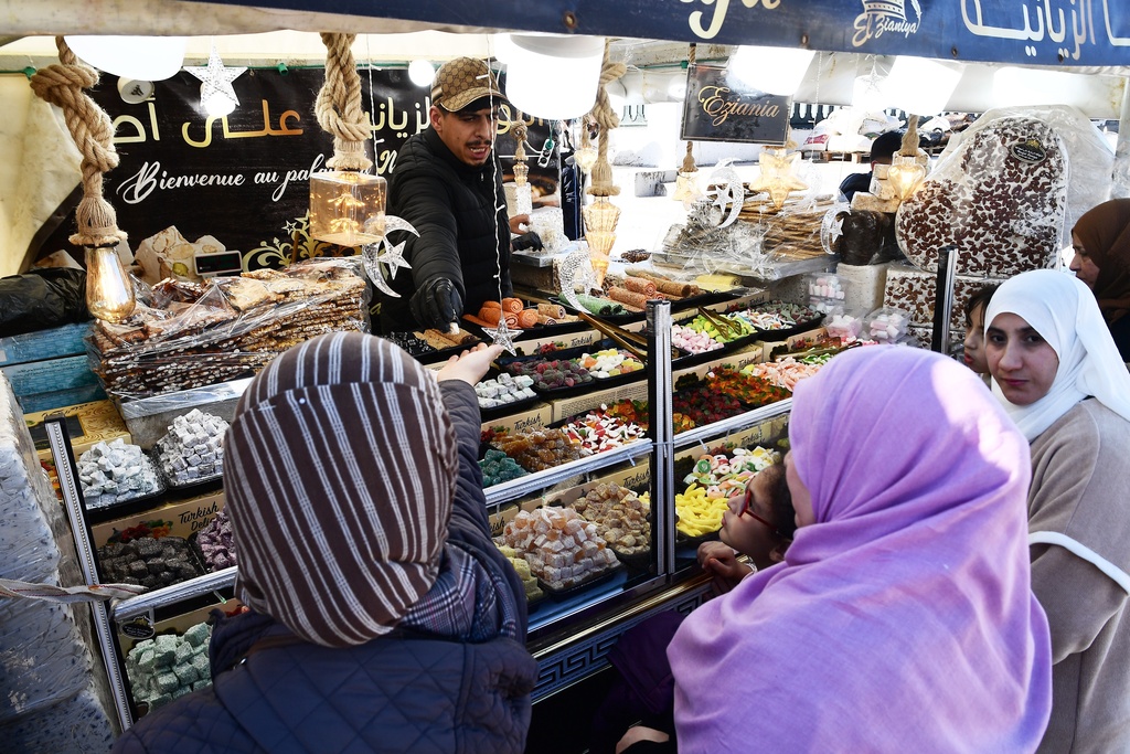 People stock up on food at a market in Algiers, Algeria, Thursday, Feb. 17, 2026. (AP Photo/Fateh Guidoum)