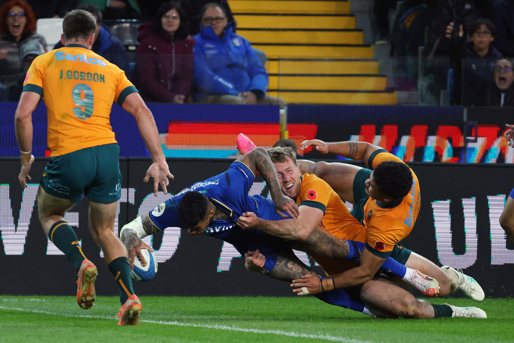 Australia's Monty Ioane scores a try during the rugby union match between Italy and Australia in Udine, Italy, Saturday, Nov. 8, 2025. (Andrea Bressanutti/LaPresse via AP)