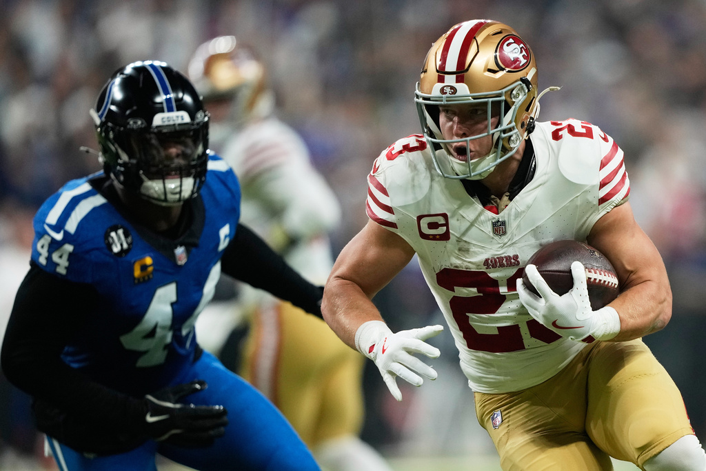 San Francisco 49ers running back Christian McCaffrey (23) runs against Indianapolis Colts outside linebacker Zaire Franklin (44) during the first half of an NFL football game, Monday, Dec. 22, 2025, in Indianapolis. (AP Photo/Carolyn Kaster)