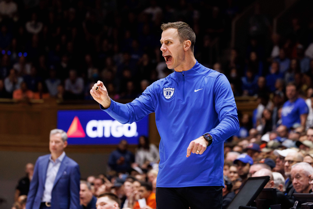 Duke head coach Jon Scheyer shouts towards the court during the second half of an NCAA college basketball game against Virginia in Durham, N.C., Saturday, Feb. 28, 2026. (AP Photo/Ben McKeown)