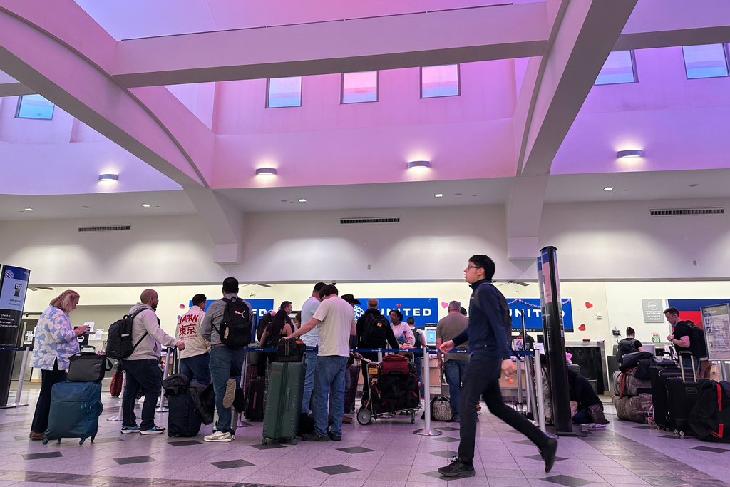 People stand in line at check-in counters at El Paso International Airport, Wednesday, Feb. 11, 2026, in El Paso, Texas. (AP Photo/Morgan Lee)