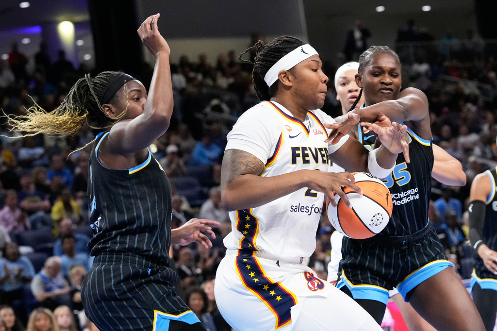 Indiana Fever forward Myisha Hines-Allen, center, battles for the ball against Chicago Sky center-forward Elizabeth Williams, left, and Aicha Coulibaly, right, during the first half of a WNBA basketball game Sunday, Aug. 23, 2026, in Chicago. (AP Photo/Nam Y. Huh)