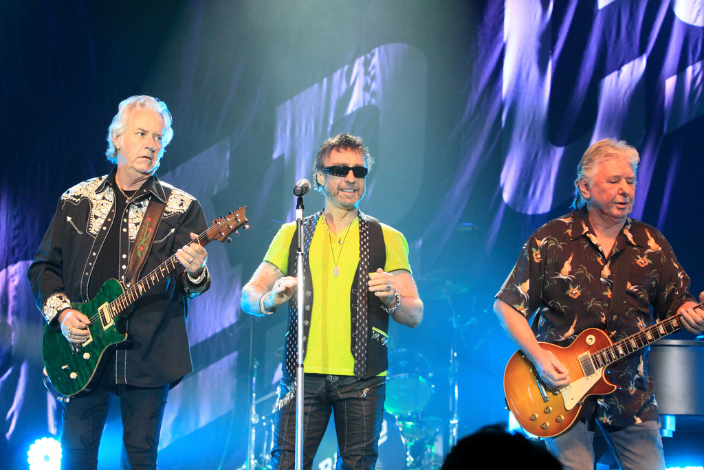 FILE - Howard Leese, from left, Paul Rodgers, and Mick Ralphs, of the classic rock band Bad Company, perform in Bethlehem, Pa., on July 29, 2013. (Photo by Owen Sweeney/Invision/AP, File)